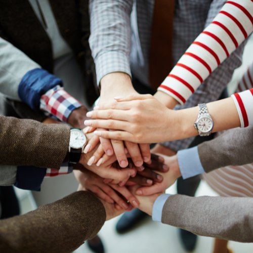 group of peoples hands all in together