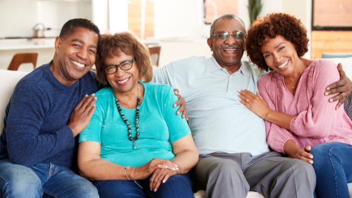 an elderly couple smiling with their sons