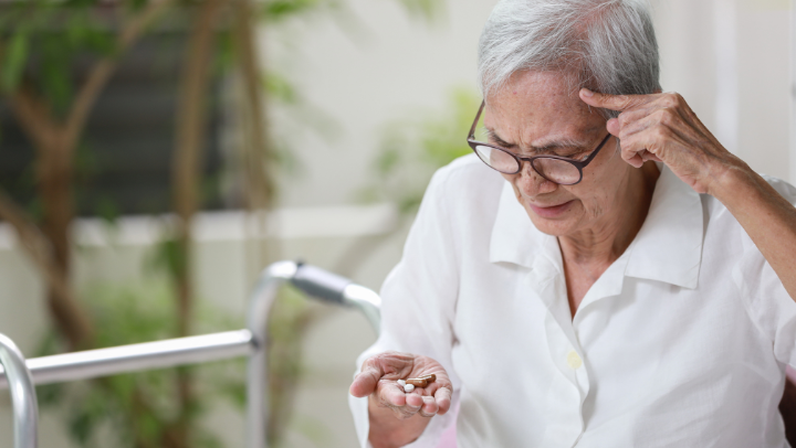 old guy looking at medicine