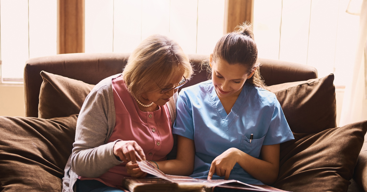 old lady reading with caregiver
