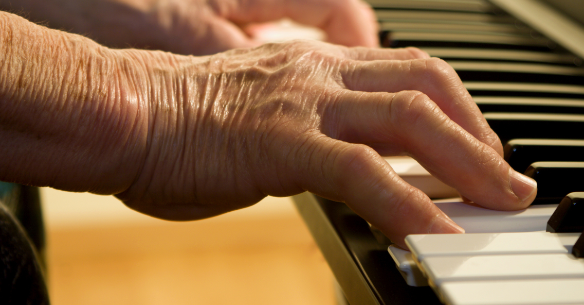 a senior playing a piano