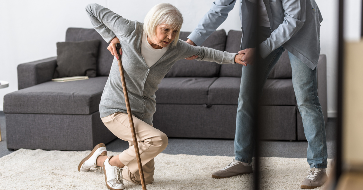 a men helping an old lady stand up