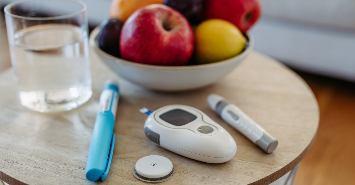 a blood glucose meter and a thermometer on a table