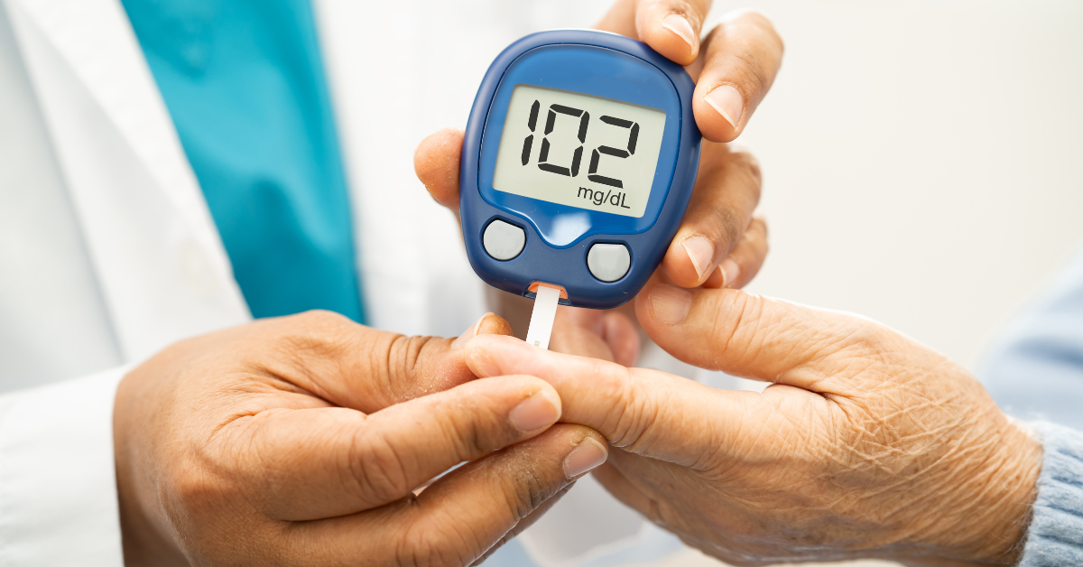 a doctor taking the glucose level in an elderly patient