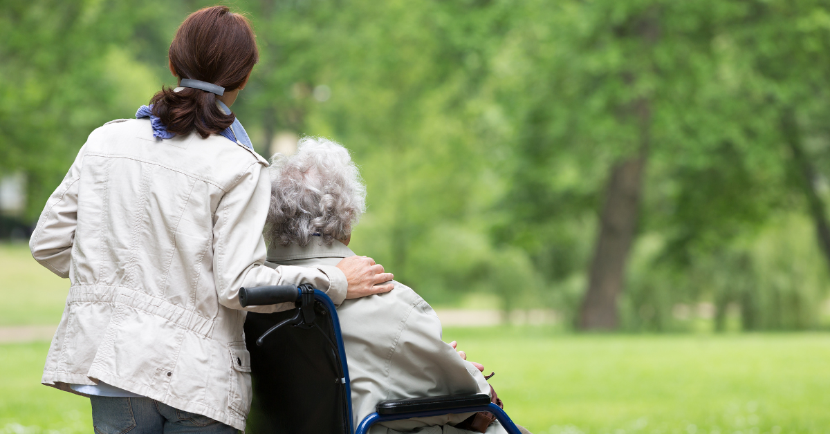 a senior lady and her daughter hugging each other in assisted living