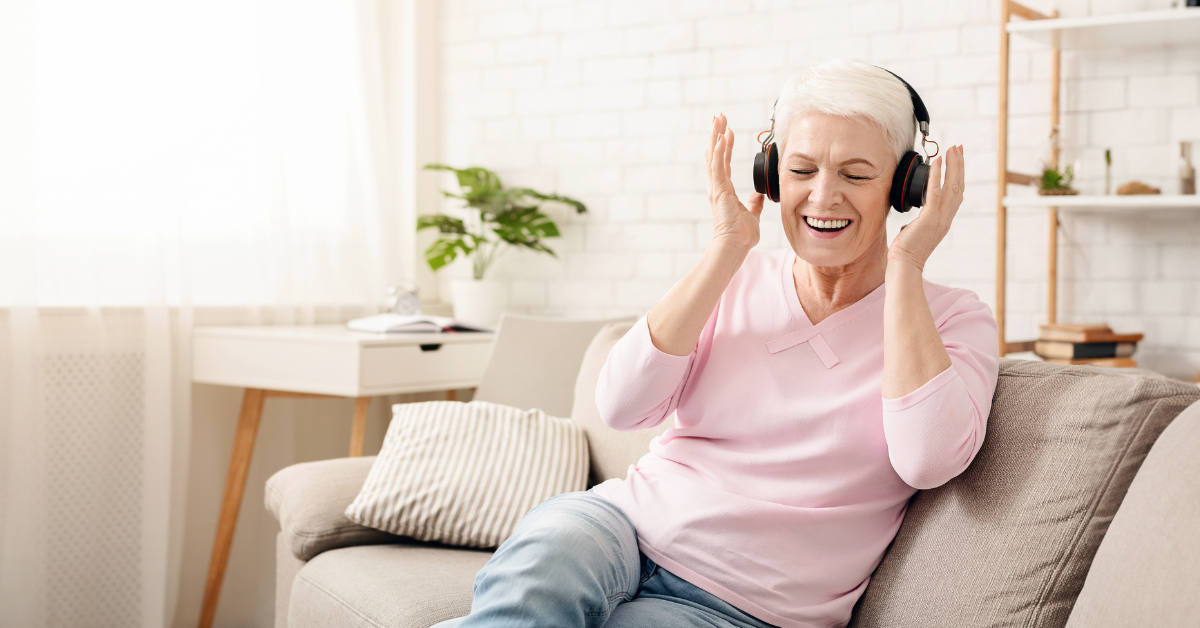a senior lady listening her favorite music at memory care