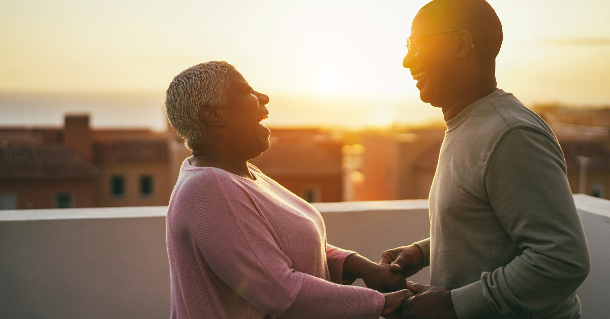 a couple of senior laughing together at independent living
