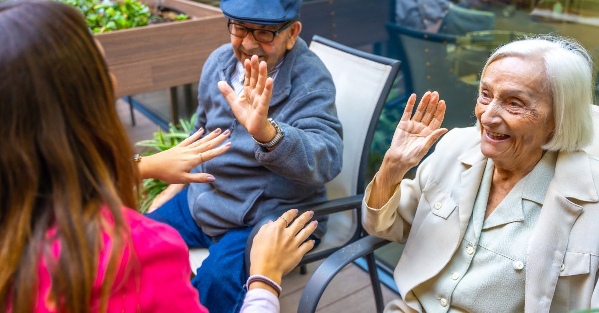 seniors smiling in an assisted living community